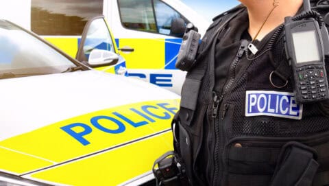 Police officer and police car - scene of emergency services' cop